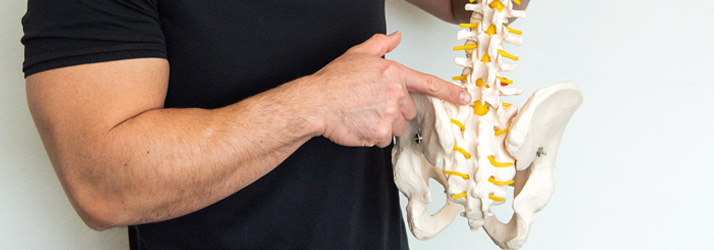 Chiropractor McKinney TX Joseph Ruane Pointing at Spine What To Expect